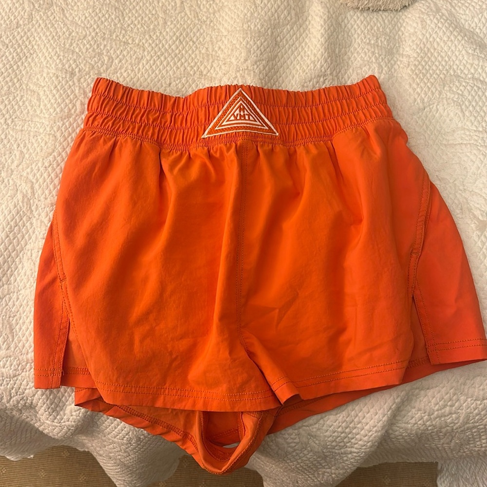 Free People movement orange athletic shorts